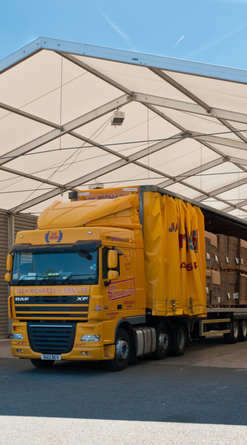 Yellow-lorry-parked-in-an-aganto-temporary-canopy-for-loading